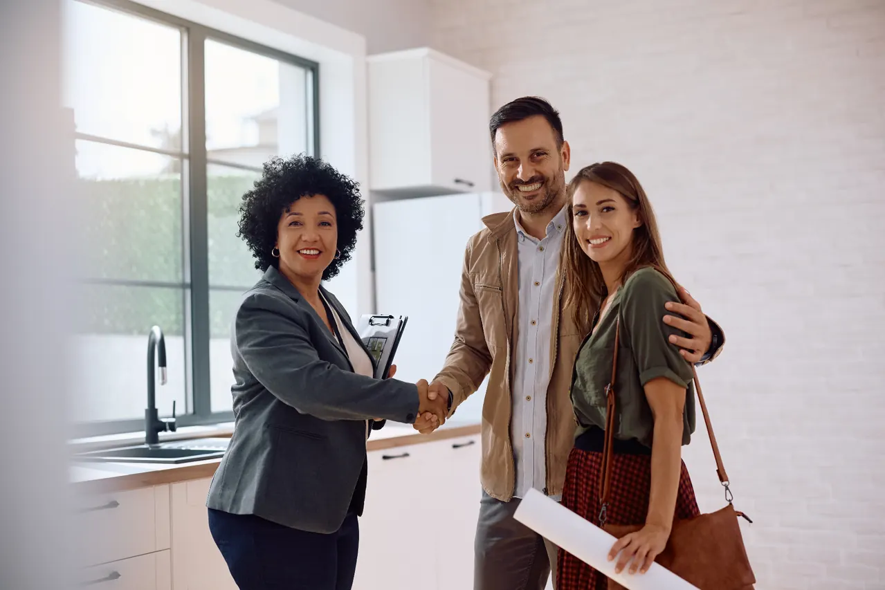 Happy clients shaking hands after a successful signing